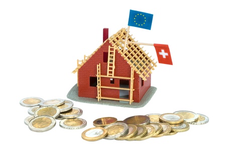 House under construction with Euro coins around itの写真素材