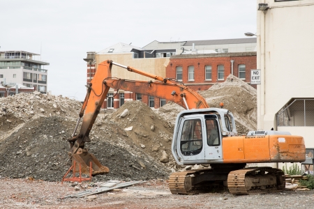Digger destroys house in urban surroundingsの写真素材