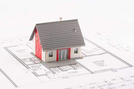 Model of a family house on a blueprintの写真素材
