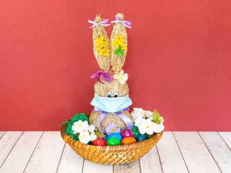 Funny Easter Bunny with easter eggs and Coronavirus face maskの写真素材