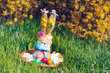Funny Easter Bunny with easter eggs and COVID-19 Coronavirus face mask