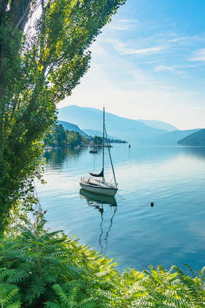 Sailing boat at an Austrian lake in the Alps. Idyllic scenery during a summer holiday.の写真素材