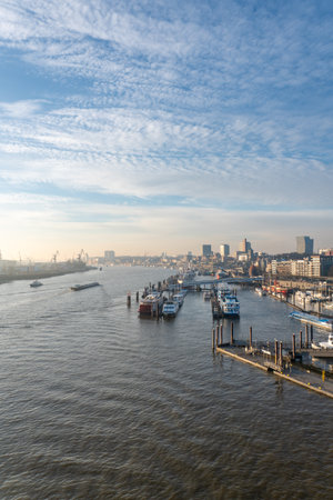 Sunrise Over Hamburg Harbor with Boats, Docks, and Waterfront View of the Port and Industrial Skylineの写真素材