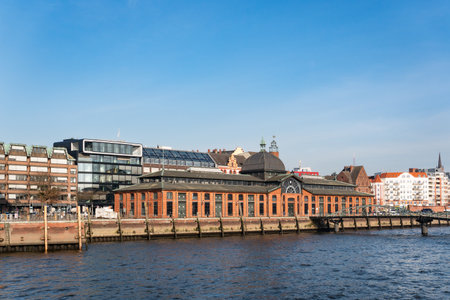 Historic Fischauktionshalle and waterfront architecture in Hamburg on a sunny dayの写真素材