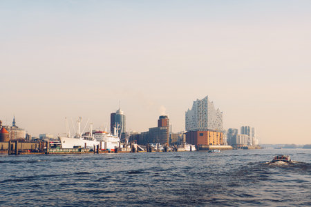 Cinematic Waterfront View of Hamburg with Elbphilharmonie at Sunsetの写真素材