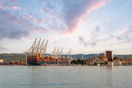 Container Terminal and Historic Waterfront of Koper at Sunset in Sloveniaの写真素材