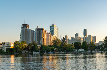 Vienna business skyline in summer. Romantic Sunset at the Alte Donau with view to office buildings.