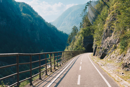 Alpe Adria bicycle trail through alpine mountain valley in Northern Italyの写真素材