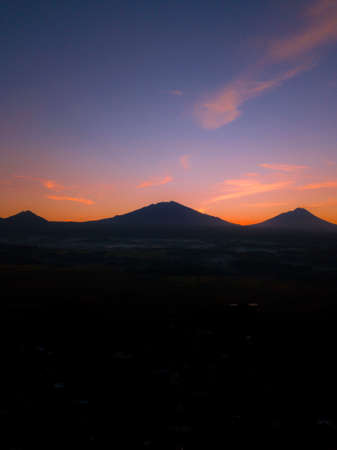 Mountain range silhouette with sky at sunriseの写真素材