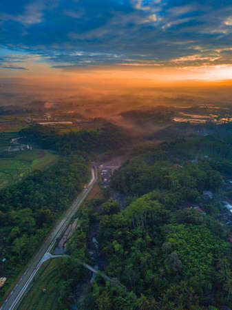 Rural view of countryside of indonesia hill and forest with mountain on the background.の写真素材