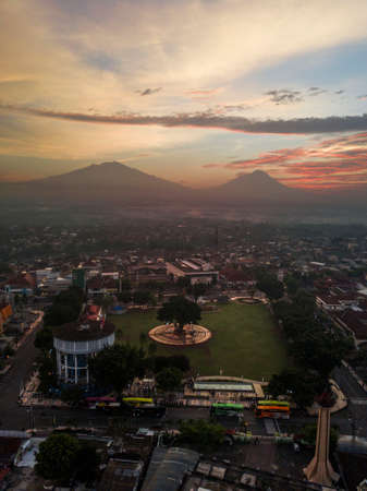 Magelang townsquare with iconic building in sunrise time with mountains on the background.の写真素材