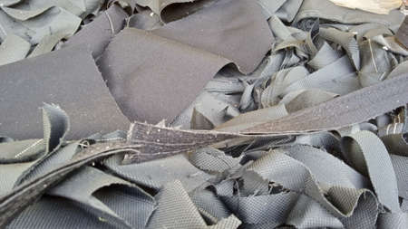 Black cloth waste is the result of the company's production processの写真素材