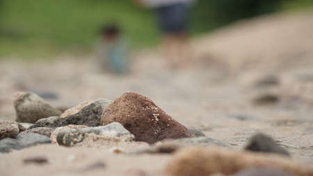Rocky white sand beach with blurry background. Focus on the rock. Jungwok Beach, Yogyakarta, Indonesiaの写真素材