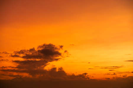 Golden sunrise in cloudy Skyの写真素材