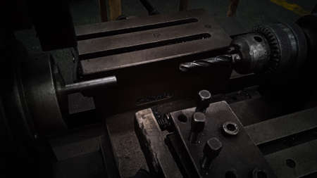 The CNC lathe machine or Turning machine drilling the metal rod with the drill tool and center drill...