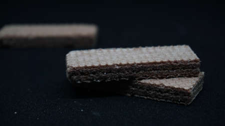 Sweet wafers on black background, flat lay. Sweet food. Background textureの写真素材