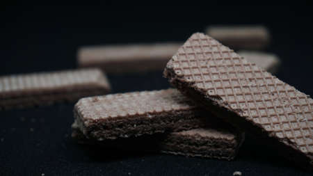 Sweet wafers on black background, flat lay. Sweet food. Background textureの写真素材