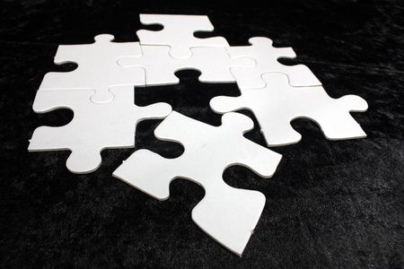 blank white jigsaw with black backgroundの写真素材