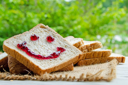 sliced breads with jam smiling signの写真素材