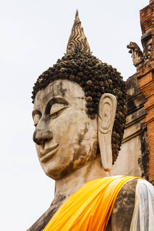 Ancient Buddha statues against at Wat Yai Chai Mongkol in Ayutthaya, Thailandの写真素材