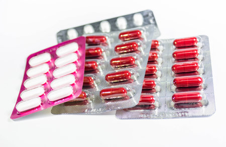 colorful capsules and pills closeup on whiteの写真素材