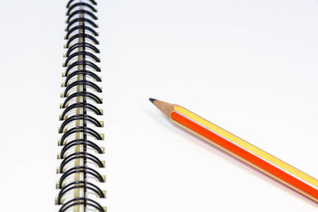 Notepad with ball pen on a white backgroundの写真素材