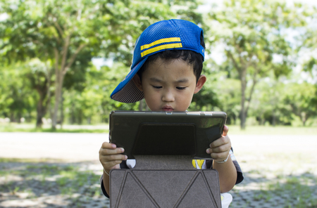 serious child playing game ontabletの写真素材