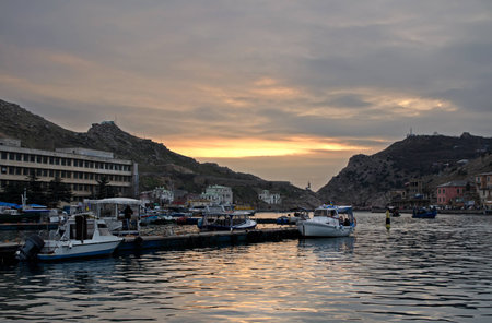 Closed bay with rows of boats, surrounded by mountainsの写真素材