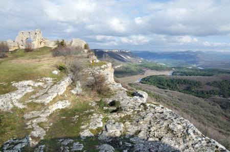 Rocks and remains of the buildings of the ancient city. Mountains on the horizonの写真素材
