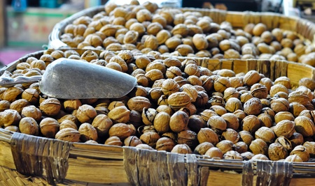a basket filled with walnuts displayed on a street marketのeditorial素材