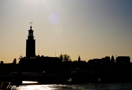 backlit silhouette of stockholms skyline showing the city hallの写真素材