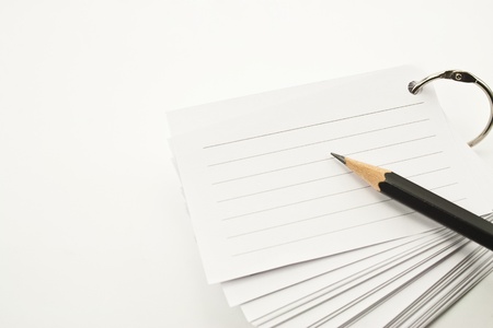 book of lined paper white ring binder and pencil on white backgroundの写真素材