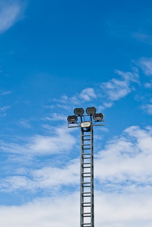tower of spot-light or flood light against bright blue sky の写真素材