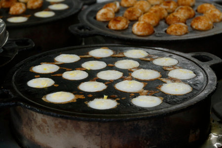 Thai sweetmeat,Thai dessert made from glutinous rice flour. Coconut rice pancake, a kind of Thai sweetmeat, Khanom Krog, Thai coconut pudding.の写真素材