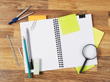Blank notebook with supplies on whiteの写真素材