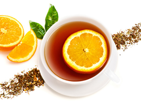 Cup of tea with orange slices, isolated on whiteの写真素材