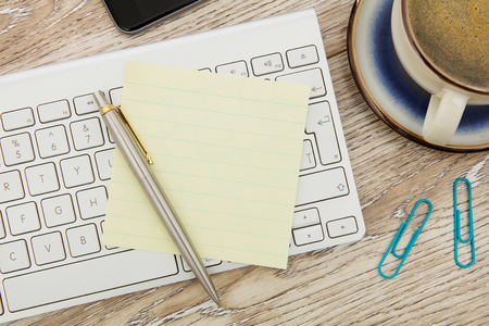 Adhesive note on deskの写真素材