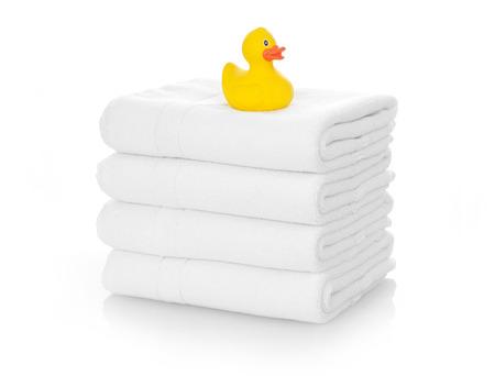 Rubber duck on white towelsの写真素材