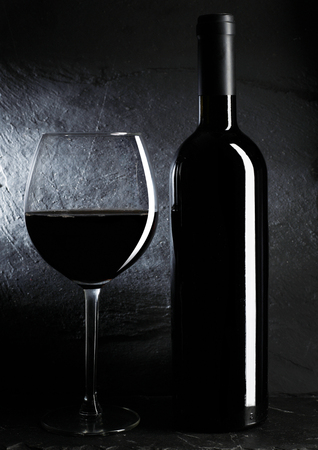 Bottle and glass of red wineの写真素材
