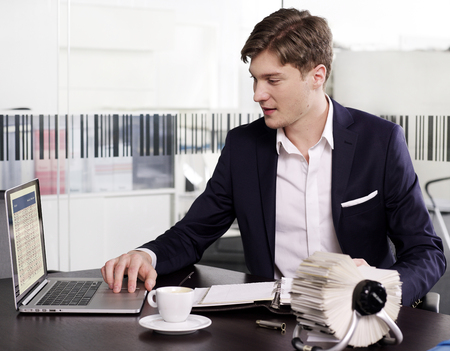 Businessman at office working laptopの写真素材