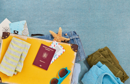 Travel suitcase packing from aboveの写真素材