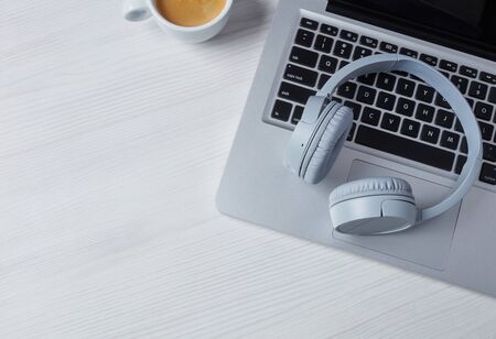 Headphones, laptop and coffee from aboveの写真素材