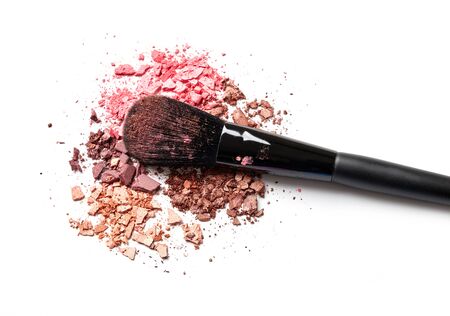 Make-up brush and crushed  eye shadow isolated on whiteの写真素材