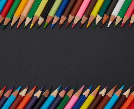 Multi-colored pencils on black backgroundの写真素材
