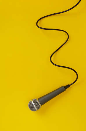 Microphone with cord on yellow backgroundの写真素材