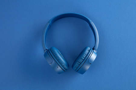 Blue headphones on blue background