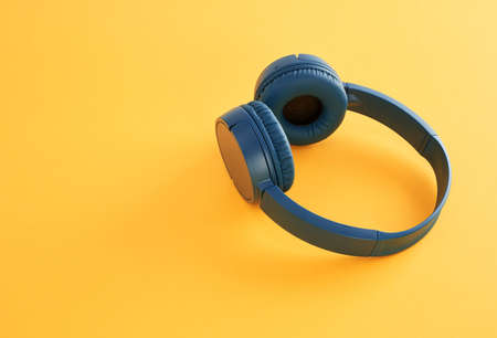 Blue headphones on yellow background