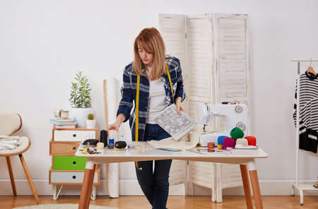 Young designer with dress bluprints