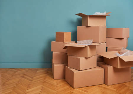 Moving boxes in a green roomの写真素材