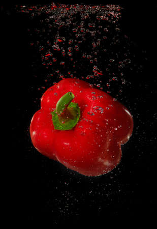 Red pepper with bubbles underwaterの写真素材